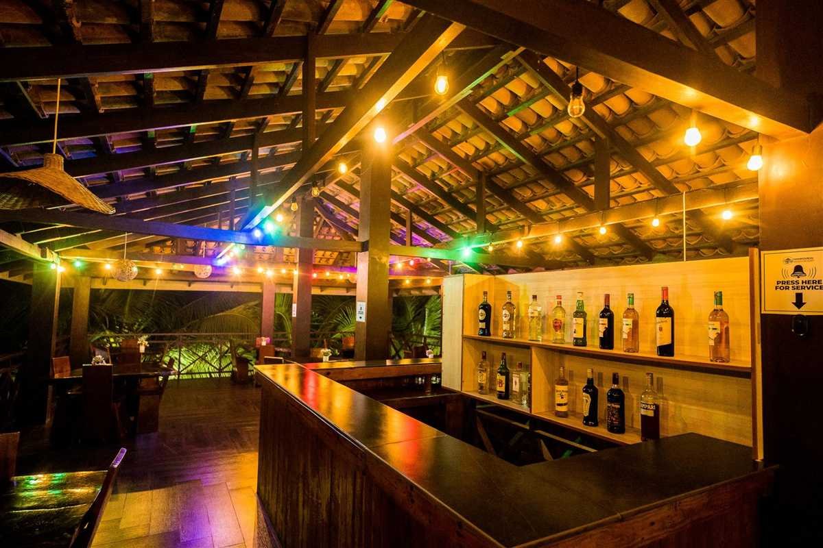 The thatched beach bar at night, strung with lights